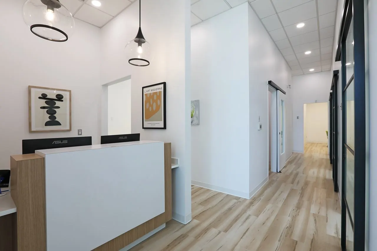Reception desk and hallway to the treatment rooms at Radiant Dental